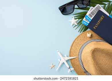 Top view of summer travel essentials including hat, passport, and sunglasses on a light blue background - Powered by Shutterstock