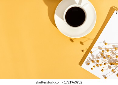 Top View Sunny Orange Desktop With A Blank Notebook And A Cup Of Coffee. Flat Lay, Minimal. Planning, To-do List, Office Work In The Summer.