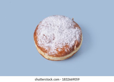 Top view of sweet pastries with filling, sprinkled with powdered sugar. Isolated on a blue background. High-calorie food.