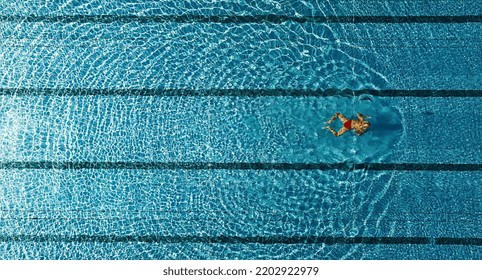 Top View Of Swimming Pool From Drone Above Of Swimming Woman In Red Bikini At Hotel 