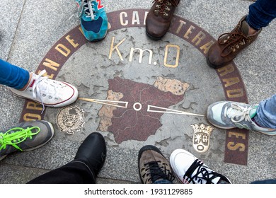 Top view of a symbol called Zero kilometre from Spain, with nine feet around. Place marked on the floor that is a sketch of the design of Spain, something symbolic.Popular meeting place Puerta del Sol