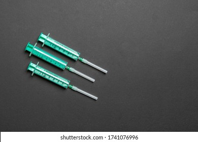 Top view of syringes in a row for medical injection on colorful background with copy space. Health and vaccination concept.