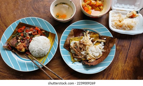 Top view of a table full of authentic traditional khmer food for breakfast of Trei boeng kanh chhet or spicy fried fish and Bai sach chrouk or pork with steamed rice