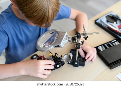 Top View Table With Kid Inventor Assambling Radio Control Robot