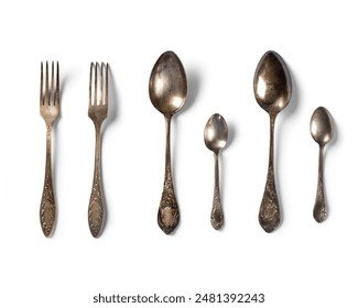 Top view of  tablespoon, fork and teaspoon . antique vintage old metal  on white background.