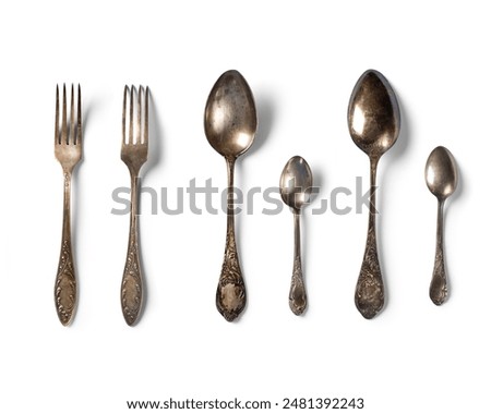Top view of  tablespoon, fork and teaspoon . antique vintage old metal  on white background.