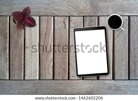 Top view Tablet PC on Wooden Desk.
