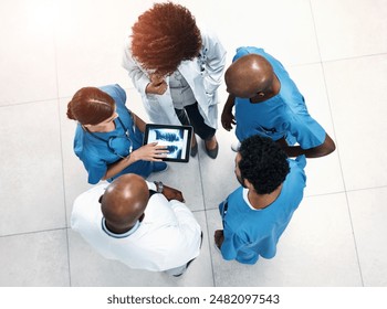 Top view, tablet screen and doctors in lobby, xray or teamwork for surgery feedback. Specialist, medical or professional with tech, advice or collaboration for healthcare, review results or people