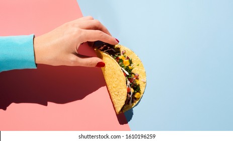 Top View Taco With Meat And Veggies Held In Hand