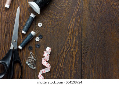 Top view tailor items on wooden background with copy space.