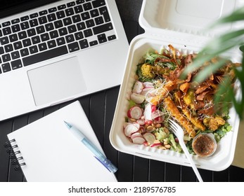 Top View Of Take Away Healthy Food With Tempura And Fresh Vegetables, Sweet Potato Chips With Plastic Fork. Office Worker Lunch Break