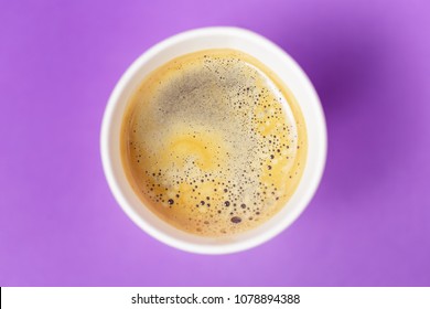 Top View Of Take-out Hot Drink In Opened Thermo Cup On Vibrant Purple Background. Cafe Crema Foam On The Americano Coffee