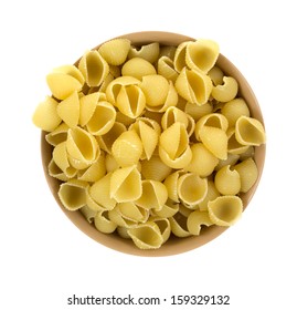 Top View Of A Tan Bowl Filled With Small Pasta Shells On A White Background.