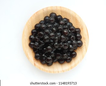 Top View Of Tapioca Ball (also Known As Boba In Bubble Tea) On Wooden Plate Isolated On White Background. It Is Ingredients For Making Pearl Milk Tea And Shaved Ice At Dessert Shop. Food Concept.