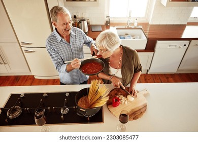 Top view, tasting or old couple kitchen cooking with healthy food for lunch or dinner together at home. Love, taste or senior woman helping or eating with mature man in meal preparation in retirement - Powered by Shutterstock