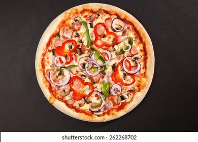 Top view tasty italian pizza on dark background 