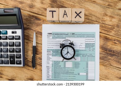 Top View Tax Form 1040 With Pen, Calculator And Black Alarm Clock. Tax Time. Financial Document.