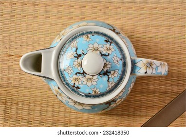 Top View Of Tea Pot On The Mat