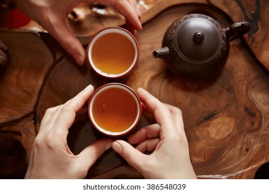 Top view tea set a wooden table for tea ceremony background. Woman and man holding a cup of tea 