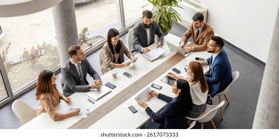 Top view of team collaborating and working on case study at boardroom.