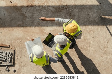 Top view, Team engineer building inspection use tablet computer and blueprint working at construction site. Civil Engineer, Contractor and Architect discussing in construction site. - Powered by Shutterstock - Get 15% off with code: PIKWIZARD15