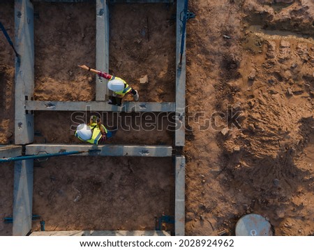 Top view team engineer working inspection beam structure installation in construction site.