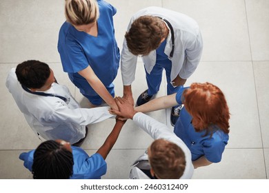 Top view, teamwork or hands of doctors in stack with mission in collaboration for healthcare support. Hospital clinic, people or group of medical nurses with solidarity, motivation or community help - Powered by Shutterstock