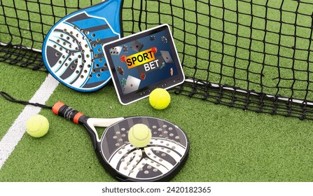 top view of tennis racket and ball near digital tablet with blank screen on green grass, sports betting concept - Powered by Shutterstock