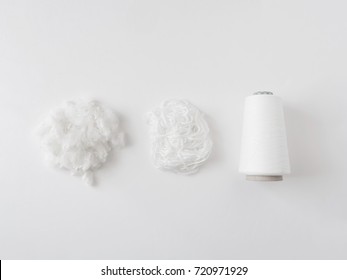 top view of Textile industry concept with yarn spools, fiber and Wool Roving on white background.