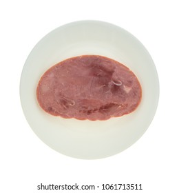 Top View Of A Thick Slice Of Ham On A Plate Isolated On A White Background.