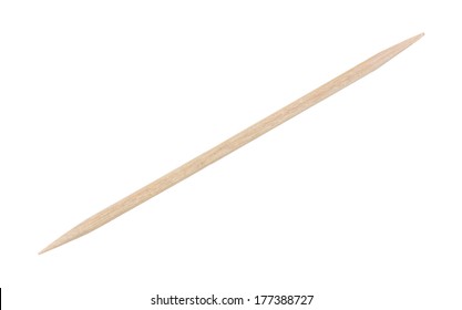 A top view of a thin wooden tooth pick used to remove food particles from between teeth.
