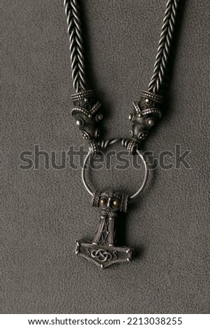 Top view of a  thors hammer.
 with with necklace as viking jewelry concept.
