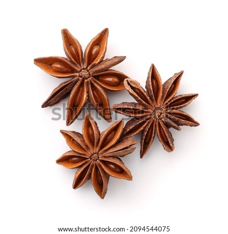 Top view of three dry star anise spice fruits isolated on white