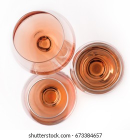 Top View Of Three Rose Wine Glasses Of Different Shapes And Sizes Isolated On White Background