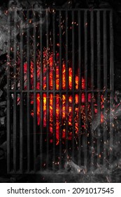 Top view through black barbecue grate of burning coals with sparks and white smoke - Shutterstock ID 2091017545