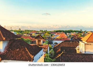 Top view of tiled roofs. Bali houses. Sunset at cozy small town. Toned with instagram retro hipster filters.