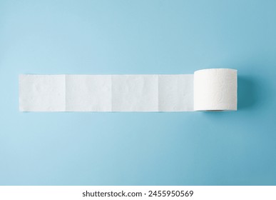 Top view of toilet paper roll on blue background