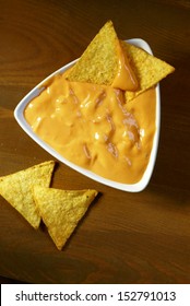 Top View Of Tortilla Corn Chips And Cheese Dip.