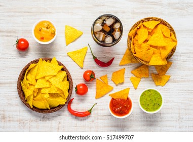 Top View Of Tortilla Corn Chips With Dip Sauce And Cold Cola Drink