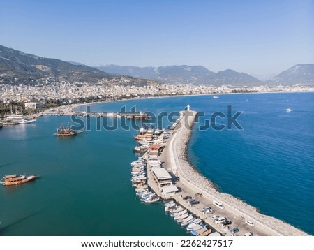 Top view of the tourist city of Alanya located between the mountains and the sea in Turkey, on a sunny summer day