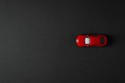 Top View Of Toy Red Car On Dark Background