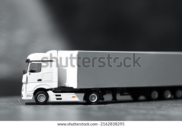 Top view of toy truck on dark background.\
Logistics and wholesale\
concept