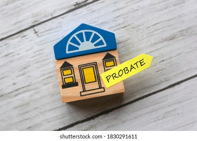 Top View Of Toy Wooden House And Sticky Note Written With Probate On White Wooden Background.