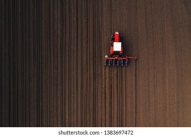 Top View Of Tractor Planting Corn Seed In Field, High Angle View Drone Photography