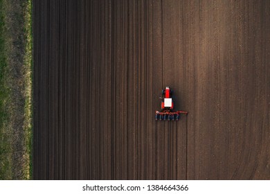 Top View Of Tractor Planting Corn Seed In Field, High Angle View Drone Photography