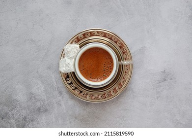Top view traditional cup of Turkish coffee with Turkish delights (Lokum) on an abstract background. - Shutterstock ID 2115819590