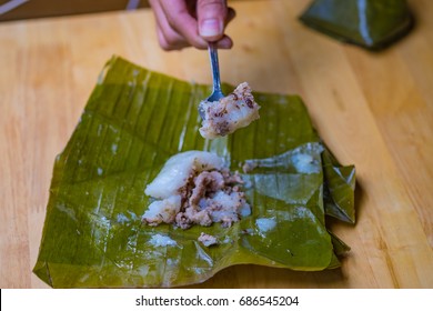 Top view of a traditional food in Vietnam call Banh Gio or pyramid shaped. Make from rice flour dumpling filled with pork , shallot and mushrooms , wrapped in banana leaf. Delicious street food.