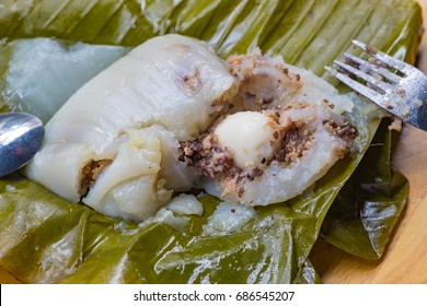 Top view of a traditional food in Vietnam call Banh Gio or pyramid shaped. Make from rice flour dumpling filled with pork , shallot and mushrooms , wrapped in banana leaf. Delicious street food.
