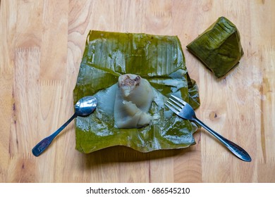 Top view of a traditional food in Vietnam call Banh Gio or pyramid shaped. Make from rice flour dumpling filled with pork , shallot and mushrooms , wrapped in banana leaf. Delicious street food.