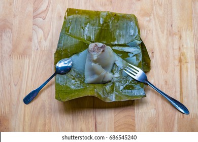 Top view of a traditional food in Vietnam call Banh Gio or pyramid shaped. Make from rice flour dumpling filled with pork , shallot and mushrooms , wrapped in banana leaf. Delicious street food.